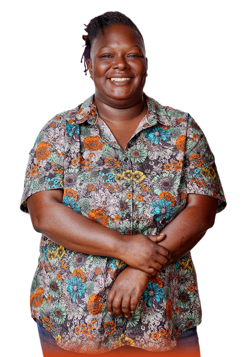Veteran female smiling and wearing a floral button down shirt