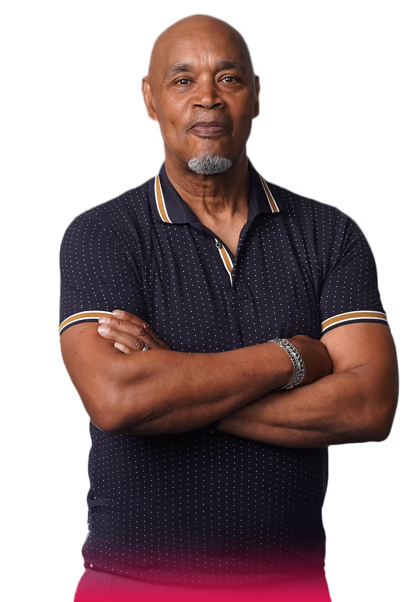 middle aged man wearing a navy blue   
polo with his arms crossed