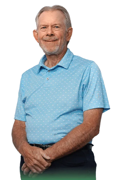 senior man in blue short sleeve shirt smiling with one hand holding the other arm